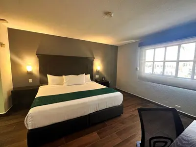 Cama o camas de una habitación en InHouse Hotel Obregón