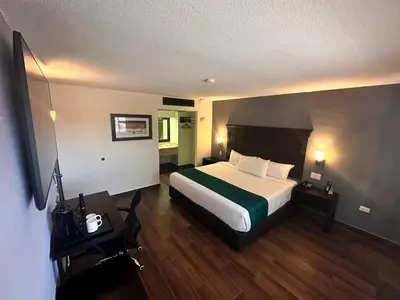 Cama o camas de una habitación en InHouse Hotel Obregón