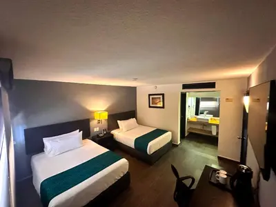 Cama o camas de una habitación en InHouse Hotel Obregón