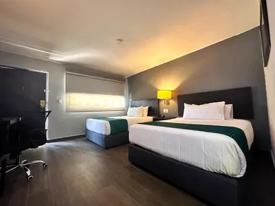 Cama o camas de una habitación en InHouse Hotel Obregón