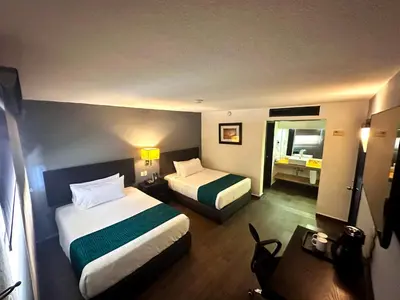 Cama o camas de una habitación en InHouse Hotel Obregón