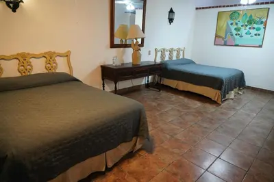 Cama o camas de una habitación en Hotel la Mansión