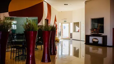 Zona de estar de American Inn Hotel & Suites Delicias