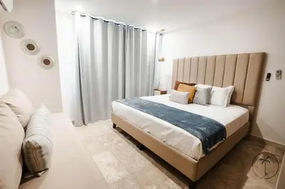 Cama o camas de una habitación en Nice apartment with a pool and gym in Mazatlán