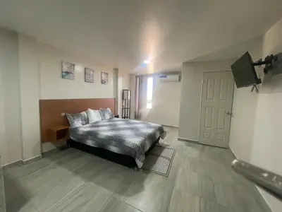 Cama o camas de una habitación en Apartamentos AEROPUERTO