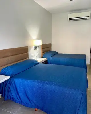 Cama o camas de una habitación en Hotel las Palmas