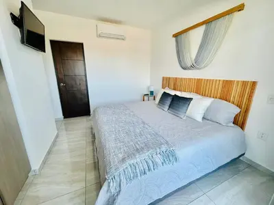 Cama o camas de una habitación en moderno con alberca cerca de la playa by G P S rentas