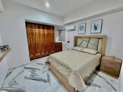 Cama o camas de una habitación en Departamento frente al mar sobre el malecón de Mazatlan