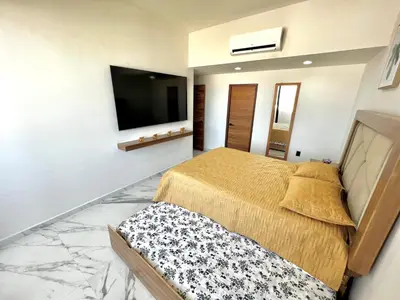 Cama o camas de una habitación en Departamento frente al mar sobre el malecón de Mazatlan