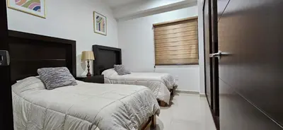 Cama o camas de una habitación en Departamento Torre Iberika Cercas Del Malecon