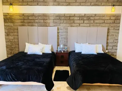Cama o camas de una habitación en Hotel Boutique Embrujo Murmullo