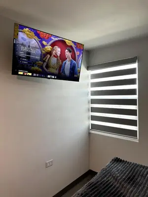 Una televisión o centro de entretenimiento en AXEL Suites Departamento 1A