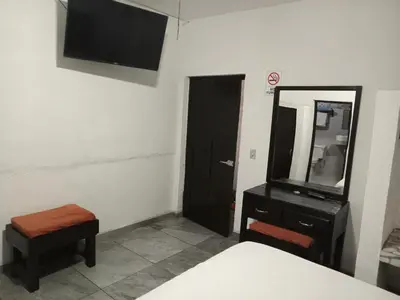 Una televisión o centro de entretenimiento en La Terraza-Habitación 2