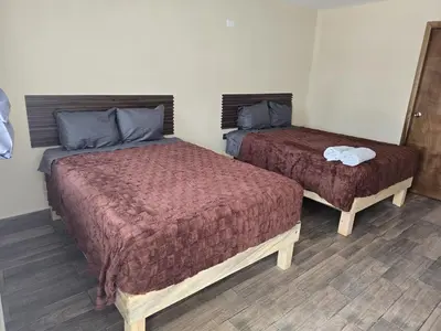 Cama o camas de una habitación en HOTEL Y CABAÑAS El PINO