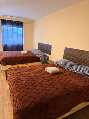 Cama o camas de una habitación en HOTEL Y CABAÑAS El PINO
