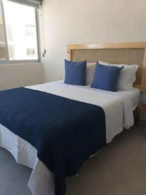 Cama o camas de una habitación en Mazablue depa en laguna con playas artificiales