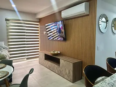 Una televisión o centro de entretenimiento en Condominio de Lujo con Laguna artificial y Hermosas Vistas