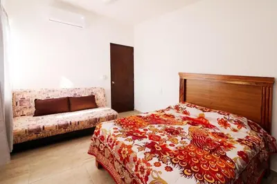 Cama o camas de una habitación en Apartamento familiar a pasos de la playa