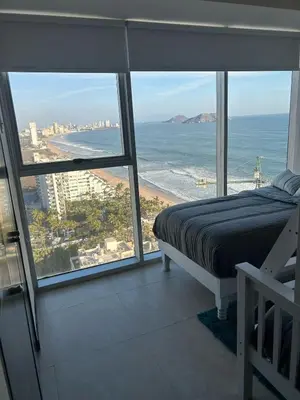 Cama o camas de una habitación en Beachfront Apartment