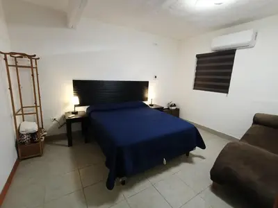 Cama o camas de una habitación en Departamento cerca del aeropuerto
