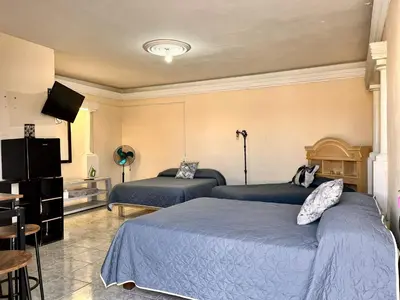 Cama o camas de una habitación en Habitaciónes Las Palmeras