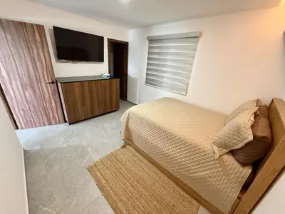 Una televisión o centro de entretenimiento en Nautilus Marina Mazatlan 216 Alberca