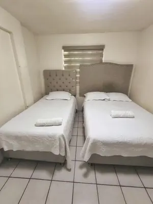 Cama o camas de una habitación en Casa céntrica con estacionamiento para 5 huéspedes