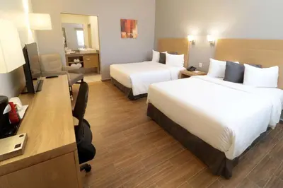 Cama o camas de una habitación en Bluu Hotel Aeropuerto Monclova-Frontera