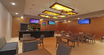 Una televisión o centro de entretenimiento en Bluu Hotel Aeropuerto Monclova-Frontera