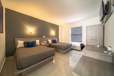 Cama o camas de una habitación en Hotel Nuve Torreón