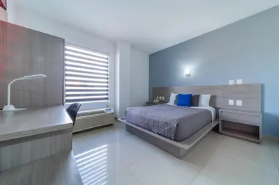 Cama o camas de una habitación en Hotel Nuve Torreón