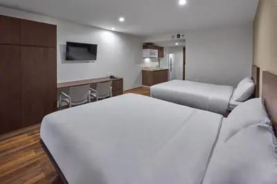 Cama o camas de una habitación en Extended Suites Ciudad Juarez Consulado