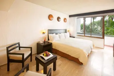 Cama o camas de una habitación en El Cid Granada Hotel & Country Club