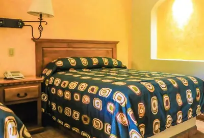 Cama o camas de una habitación en Hacienda Suites Loreto