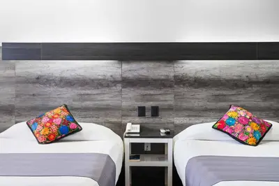 Cama o camas de una habitación en Homesuites Malecon