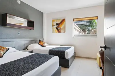 Cama o camas de una habitación en Homesuites Zaragoza