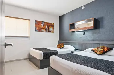 Cama o camas de una habitación en Homesuites Zaragoza