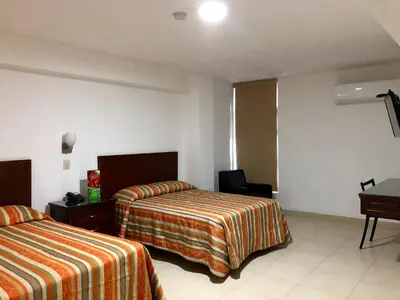 Cama o camas de una habitación en Hotel del Valle