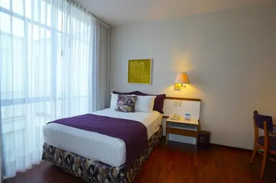 Cama o camas de una habitación en Hotel San Marcos Express