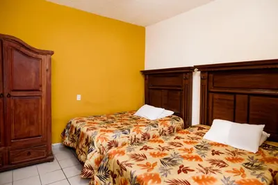 Cama o camas de una habitación en Hotel María Elena