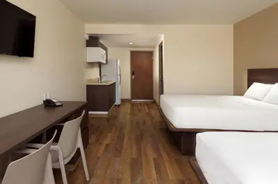 Cama o camas de una habitación en Extended Suites Chihuahua La Juventud