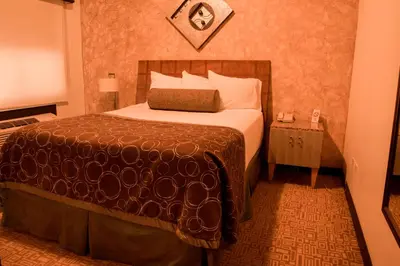 Cama o camas de una habitación en Business Hotel & Suites María Bonita