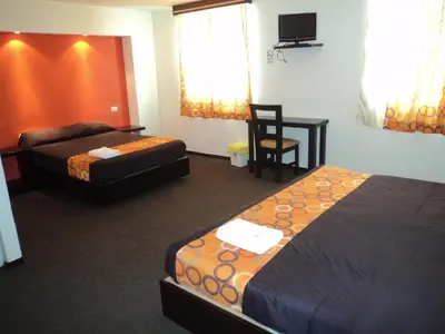 Cama o camas de una habitación en Hotel Santa Cruz Mochis