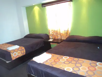 Cama o camas de una habitación en Hotel Santa Cruz Mochis