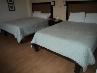 Cama o camas de una habitación en Hotel Santa Cruz Mochis