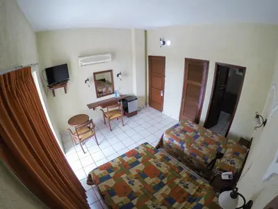 Una televisión o centro de entretenimiento en Hotel Davimar