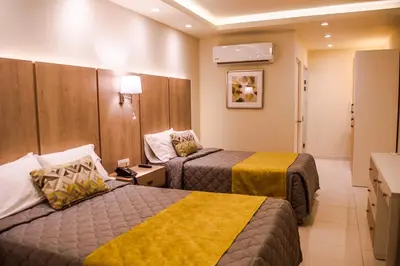 Cama o camas de una habitación en La Siesta Hotel