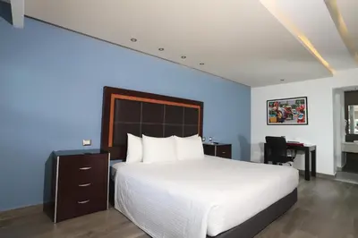 Cama o camas de una habitación en Quinta Dorada Hotel & Suites