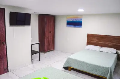 Cama o camas de una habitación en Posada Vacacional Brisas del Mar