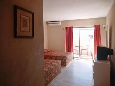 Cama o camas de una habitación en Los Jitos Hotel & Suites
